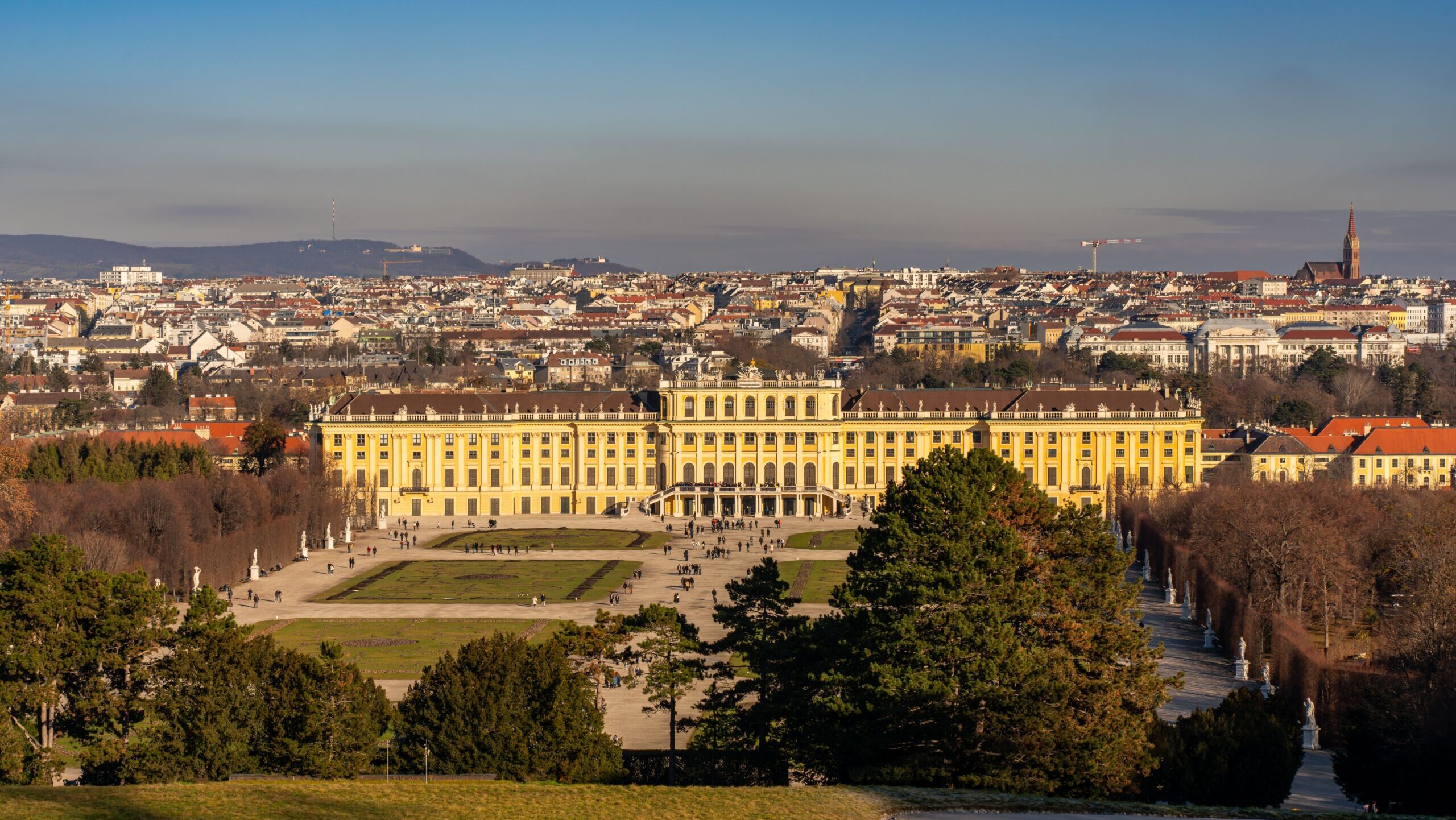 A captivating aerial view of the iconic Schönbrunn Palace in Vienna, surrounded by beautiful gardens.