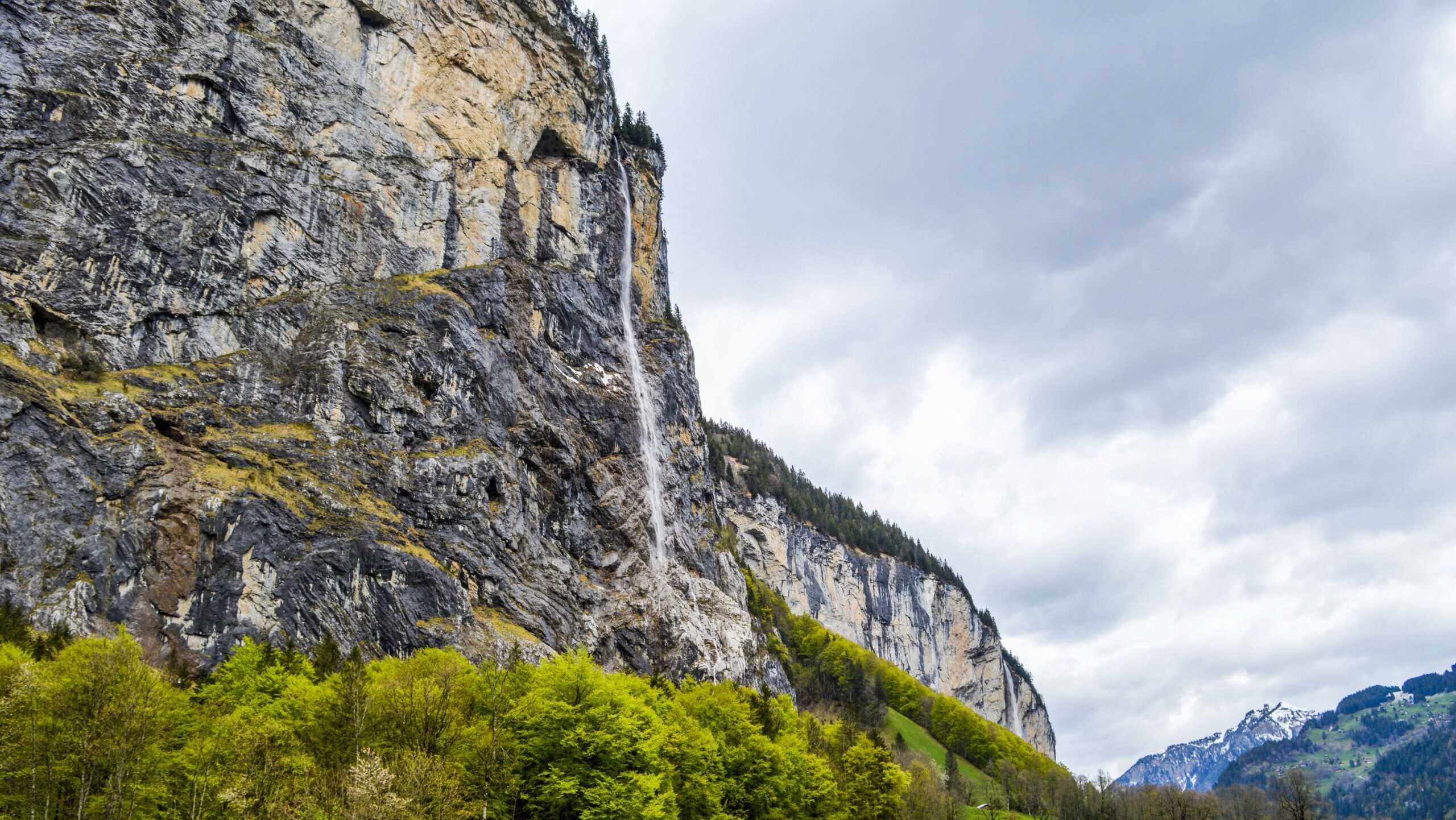 Magnificent alpine landscape of Staubbach Fall waterfall streaming through rocky mountain in peaceful countryside in Lauterbrunnen valley