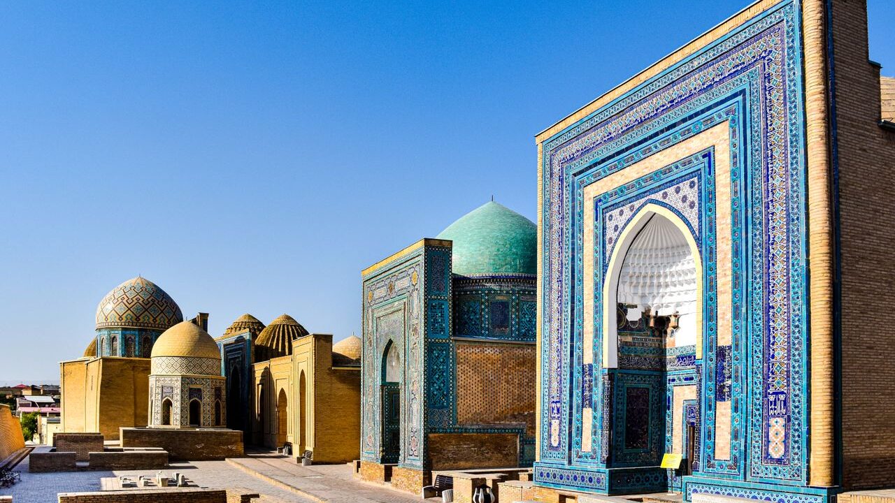 Explore the vibrant mosaics and historic domes of the Shah-i-Zinda complex in Samarkand, Uzbekistan.