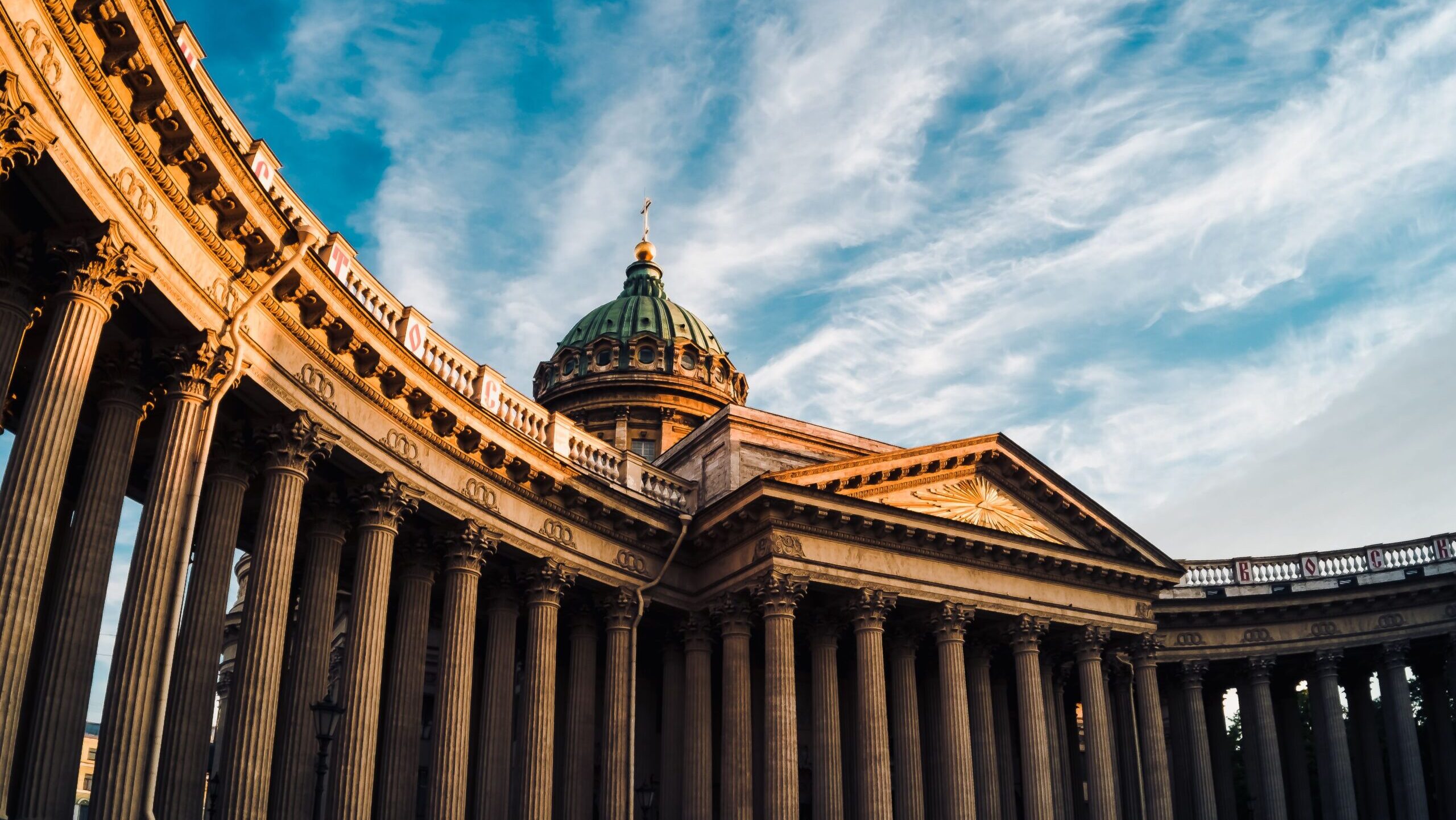 Breathtaking view of Kazan Cathedral's classic columns under a vibrant sky in Saint Petersburg, Russia.